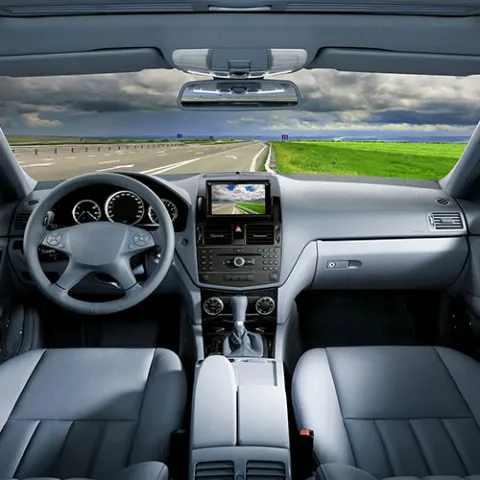 Dashboard and open road seen from inside a car